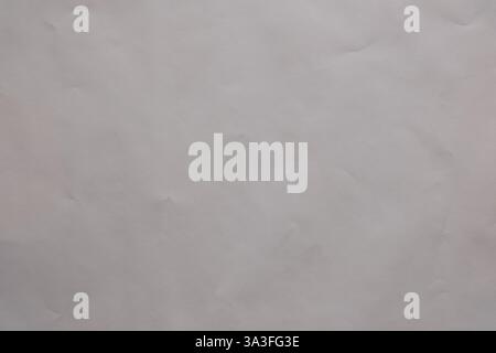 Texture and Abstract Background: The subtle play of light and shadow on a crumpled off white sheet creates an abstract canvas Stock Photo