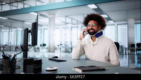 Injured worker with broken arm calling for compensation coverage on smartphone. Stock Photo