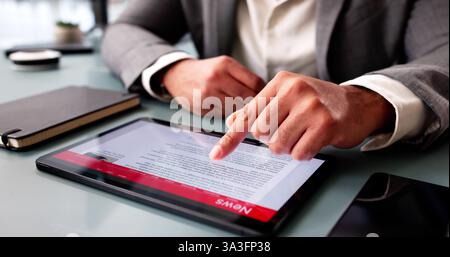 African American Man Reading Digital Tablet News Article Online Profession: Journalist Stock Photo