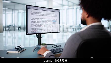 Young African American man corrects errors in digital manuscript online. Stock Photo