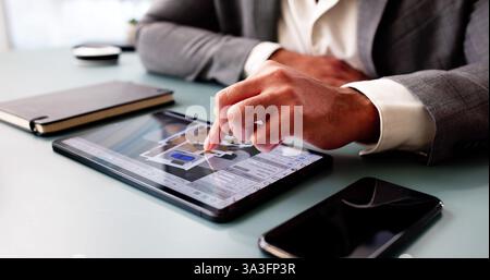 Architect meticulously examining and digitizing house floor plan design. Professional engineer. Stock Photo
