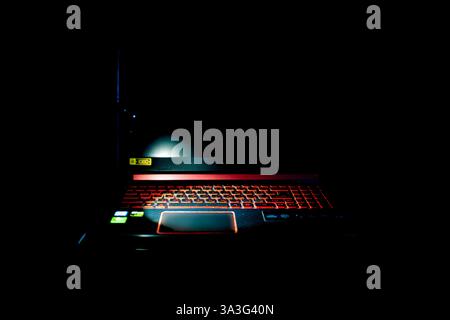 Illuminated Keyboard for gaming. Backlit keyboard with versatile color schemes on black isolated. Stock Photo