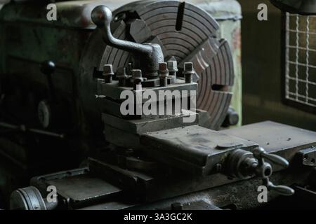 Vintage industrial lathe in an old workshop setting. Stock Photo