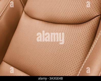Brown luxury modern car Interior. Detail of modern car interior. Part of brown leather seats with stitching in expensive car Stock Photo