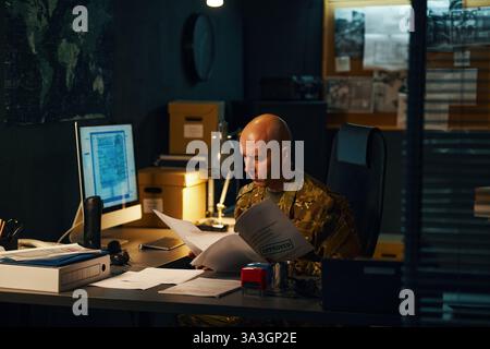 Analyzing Classified Documents in Military Office Stock Photo