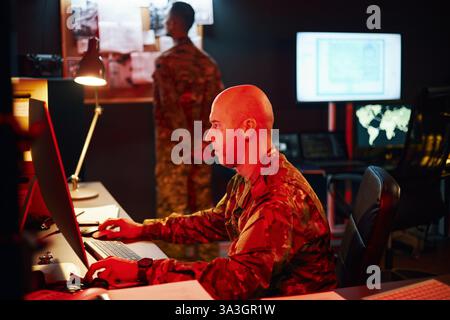 Analyzing Tactical Data in Military Command Center Stock Photo