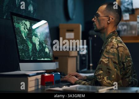 Military Personnel Analyzing Data on Computer Screen Stock Photo