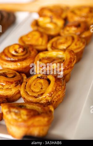 Freshly baked pastries sweet rolls displayed on buffet table in cozy bakery or cafe setting for Breakfast, Brunch and Dessert Lovers Savoring Sweet an Stock Photo