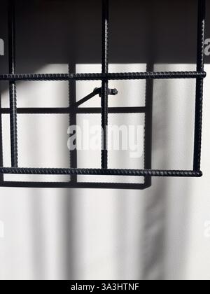 Metal Grid Casting Shadow on Wall, Abstract Composition, Light and Shadow Play. High quality photo Stock Photo