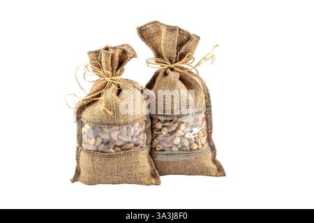 roasted salty pistachios nuts in sack bag, isolated on white background. Salted and Roasted Pistachios in a Bowl. Stock Photo