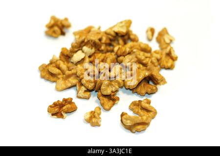Peeled walnut kernels lie in a group on a white background, ready to cook dishes Stock Photo