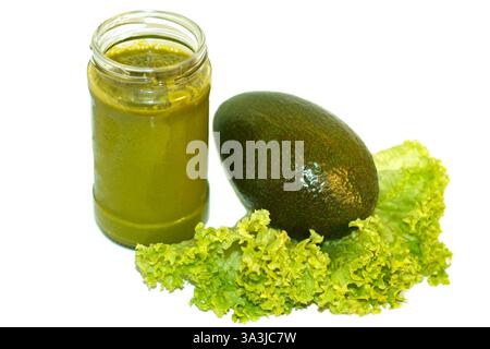 Avocado fruit and smoothie squeezed from avocado and salad leaf on a white background Stock Photo