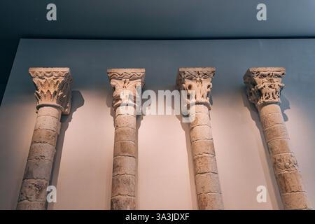 17 January 2025, Louvre museum Abu Dhabi, UAE: Four romanesque columns with sculpted capitals exhibited in a museum Stock Photo
