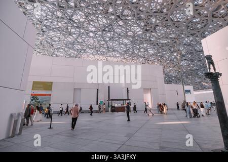 17 January 2025, Louvre museum Abu Dhabi, UAE: Tourists walking inside Louvre museum, enjoying modern geometric ceiling and art exhibitions Stock Photo