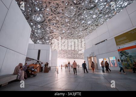 17 January 2025, Louvre museum Abu Dhabi, UAE: Tourists walking inside Louvre museum, enjoying modern geometric ceiling and art exhibitions Stock Photo