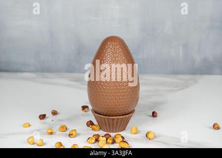 Milk chocolate Easter egg filled with hazelnut cream. Stock Photo