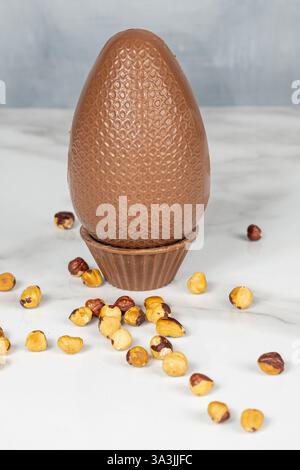 Milk chocolate Easter egg filled with hazelnut cream. vertical Stock Photo