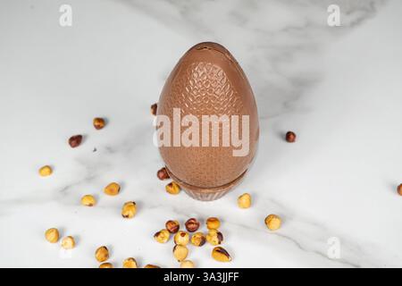 Milk chocolate Easter egg filled with hazelnut cream top view. Stock Photo