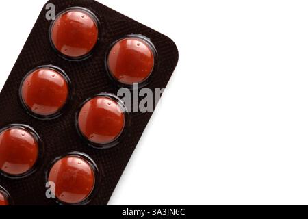 Red pills in blister pack isolated on white background. Top view Stock Photo