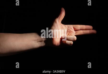 gun finger gesture on black background Stock Photo