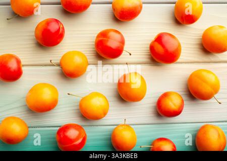 plum on blue wood background top view Stock Photo
