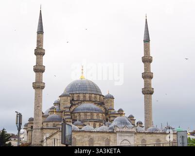 Majestic Ottoman-style mosque with a large central dome and two tall minarets against a cloudy sky Stock Photo