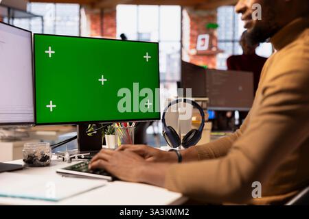 Startup entrepreneur using chroma key PC to do research, looking to grow value of company. Close up of venture business manager using isolated screen computer, developing innovative growth strategy Stock Photo