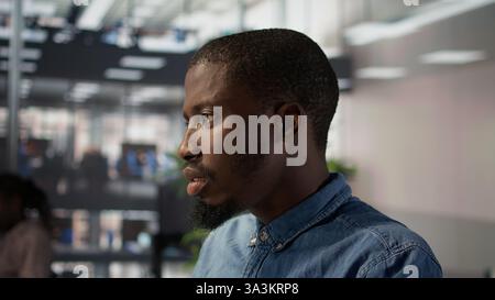 General director sits at his computer frustrated and overwhelmed by the workload of business tasks. Expert dealing with fatigue after experiencing pressure at work, tough day at the office. Camera B. Stock Photo