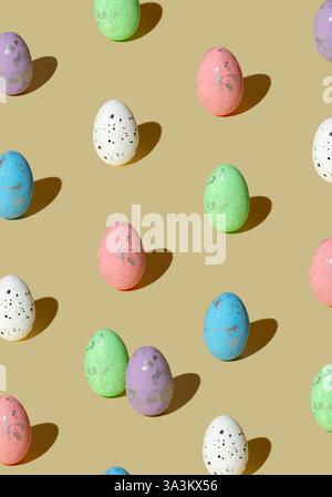 Pattern made of colored eggs on pastel beige background. Minimal Easter concept. Stock Photo