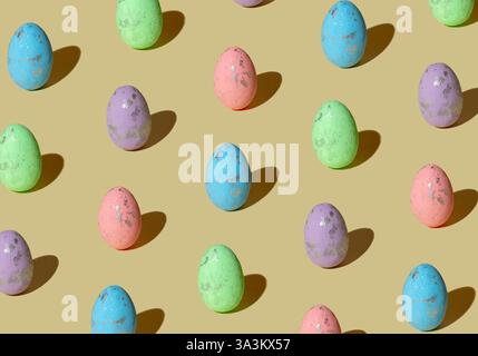 Pattern made of colored eggs on pastel beige background. Minimal Easter concept. Stock Photo