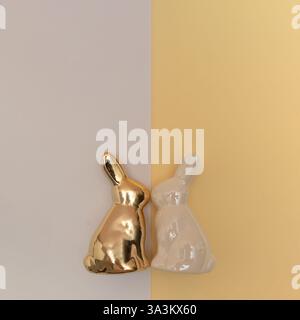 White and golden rabbits on a light background. Happy Easter concept. Close-up. Stock Photo