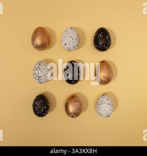Pattern made of colored eggs on pastel beige background. Minimal Easter concept. Stock Photo
