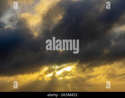 wild sunset in dark clouds Stock Photo