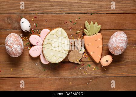 Composition with sprinkles, decor and Easter cookies on wooden background Stock Photo