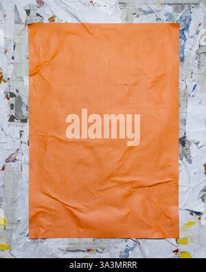 Orange vertical paper poster on dirty street style wall. collage art paper frame mockup. Stock Photo