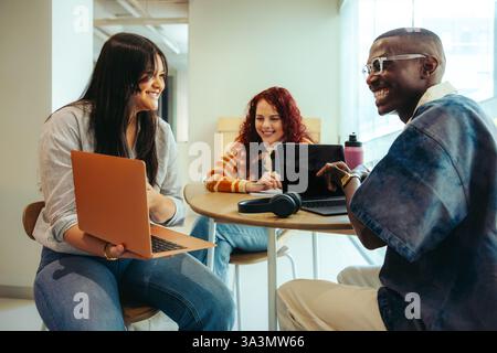 High school students engage in teamwork and creativity while collaborating on a project in a study session with laptops. Stock Photo