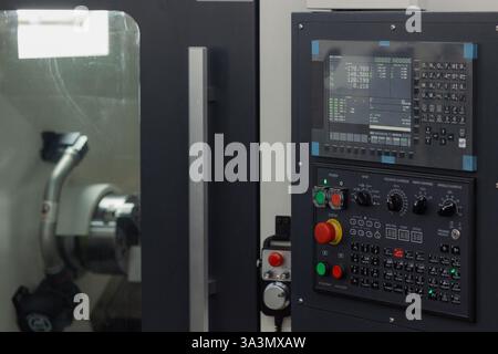Advanced machinery showcases intricate control panels with digital displays. Skilled operators engage in precision engineering, ensuring high-quality Stock Photo