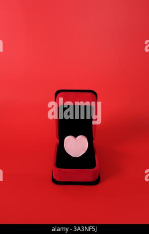 Candy Heart Sitting In Red Velvet Ring Box With Copy Space Stock Photo