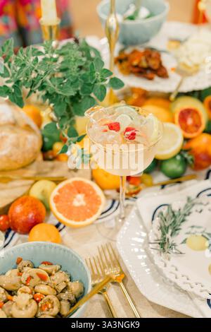 Citrus-themed table setting with cocktails and appetizers. Stock Photo