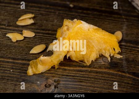 pumpkin with seeds cut into pieces, details of the pumpkin part with soft sweet flesh and large seeds Stock Photo