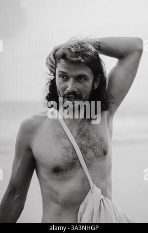 Portrait of a charismatic man with long, curly hair. Stock Photo