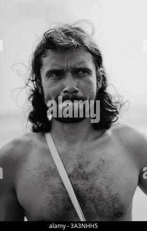 Portrait of a charismatic man with long, curly hair. Stock Photo