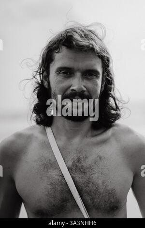 Portrait of a charismatic man with long, curly hair. Stock Photo