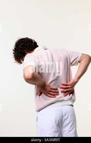 Man is suffering from urolithiasis. Feeling chronic unbearably strong pain attacks in the flanks. Struggling with osteochondrosis of transverse spine Stock Photo