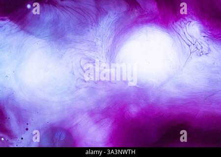 Abstract background with swirling patterns in purple and white colors. Photo is reminiscent of marble texture or the movement of ink in water. Bright Stock Photo