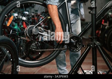 Close up view of man's hands that is repairing bicycle. Stock Photo