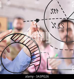 Team analyzing data-driven insights, visually mapping financial trends with pie and donut charts, fostering collaborative decision-making process Stock Photo