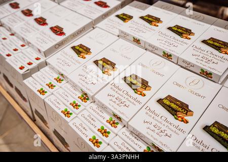 23 January 2025, Abu Dhabi, UAE: Dubai chocolate bars with kunafa and pistachio filling stacked on a store shelf, ready for purchase Stock Photo
