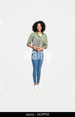 African-American woman holding a tablet is a perfect representation of the modern professional who combines technology with mobility, isolated studio shot in full length Stock Photo