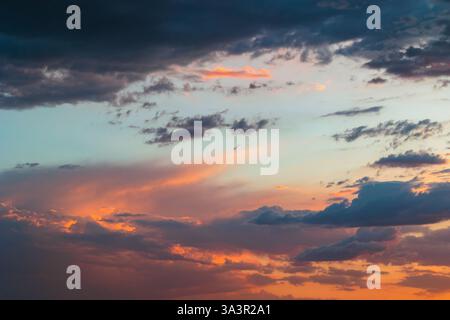 Partly cloudy sky at sunset. Dramatic clouds on the sky. Stock Photo